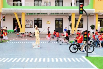 Bé thực hành an toàn giao thông trên sân